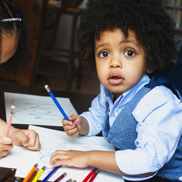 Kids coloring at a table