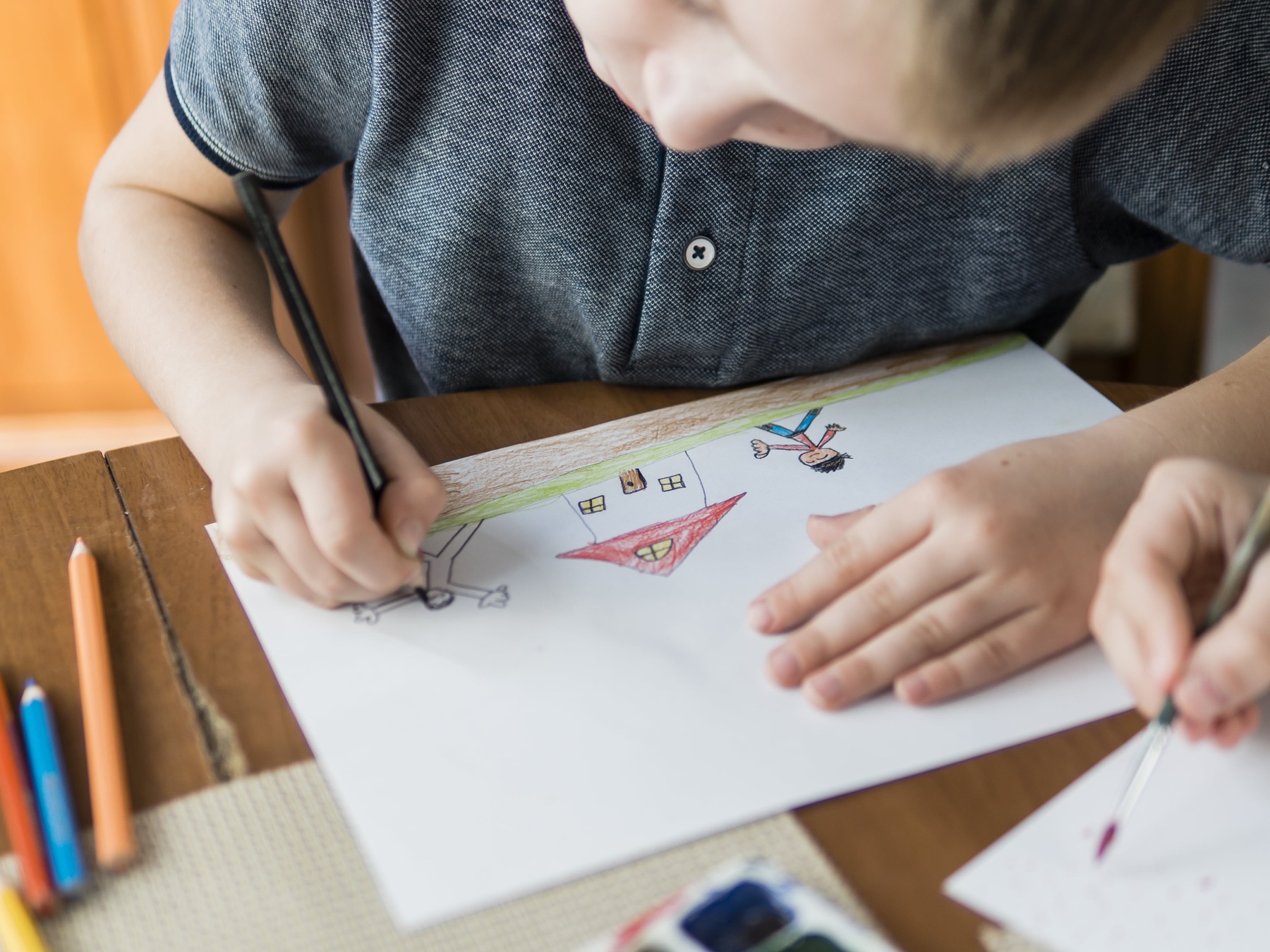 Boy carefully drawing at a desk